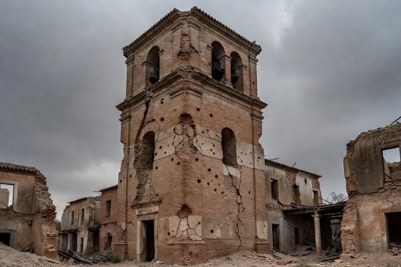 Artillery pockmarks in brick church tower of Belchite
